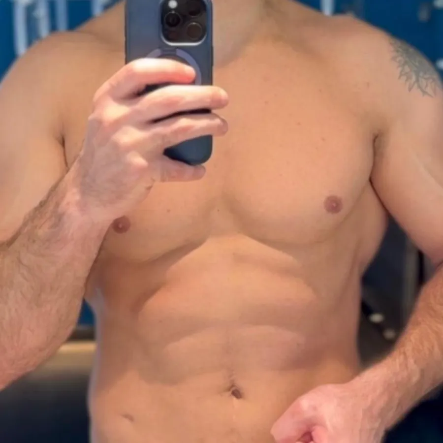The same chest and abdomen in a mirror, photographed in a different room after the sessions.